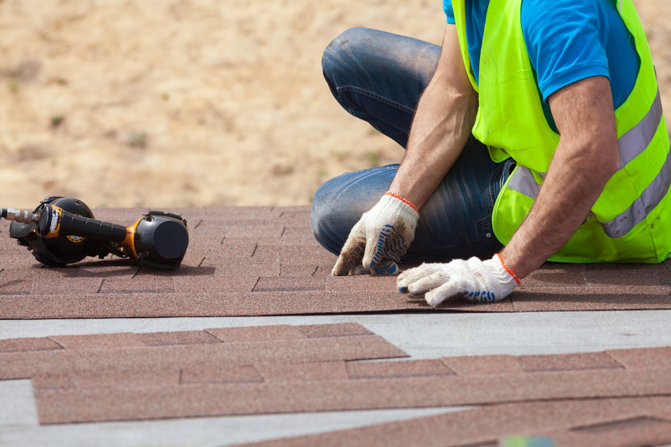 roofer fixing asphalt roof